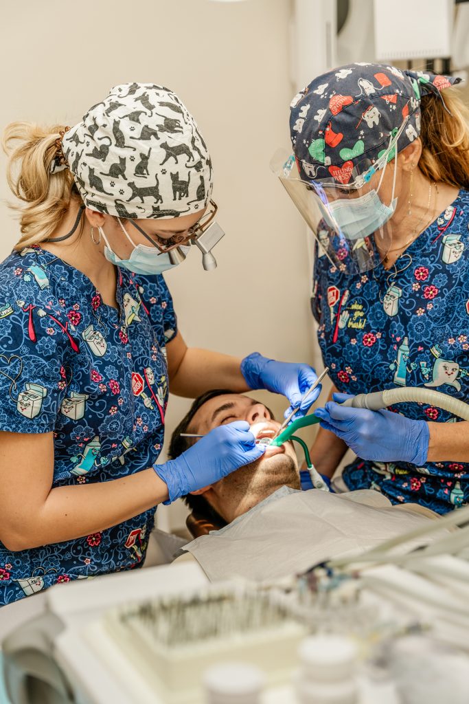 Our colleague, Dr. Virág Bognár, examines the tooth to be root-treated using a magnifying glass for more accurate results